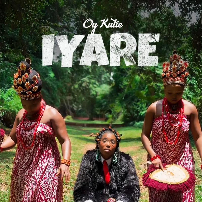 Iyare cover art: OY Kutie seated between two dancers in Edo coral regalia